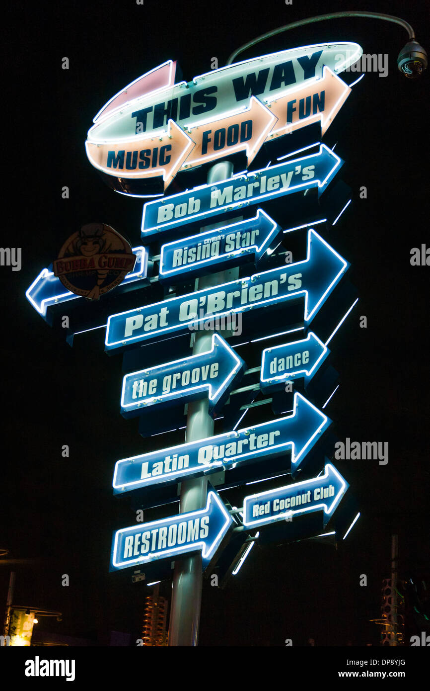 Neon Signs direct guests to bars and restaurants in City Walk at Universal Studios amusement park in Orlando, Florida Stock Photo