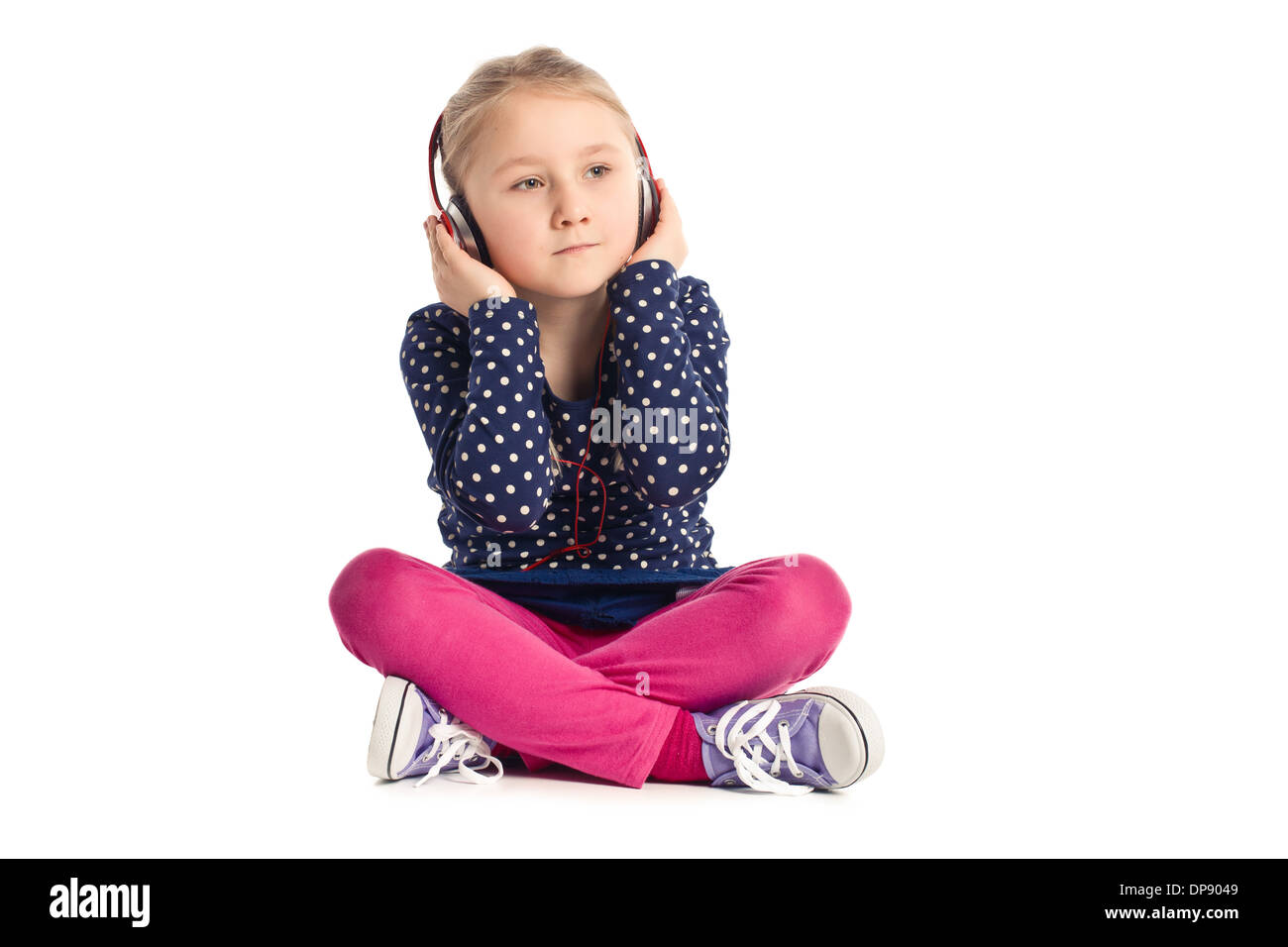 little sitting girl with headphones on white background Stock Photo - Alamy