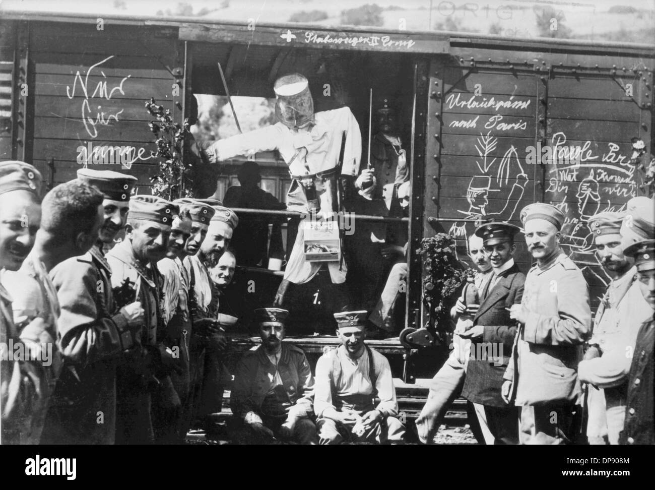 German soldiers enjoy themselves with a handcraftet puppet and writings like 'Holiday greeting to Paris' in front of a train shortly before the transportation of troops during World War I in 1914. Emperor Wilhelm II. announced the general mobilistaion on the 1st of August in 1914. Set off by the deadly shots on Austrian heir to the throne Franz Ferdinand by Serbian nationalists on the 28th of June in 1914 in Sarajevo, World War I broke out. Stock Photo