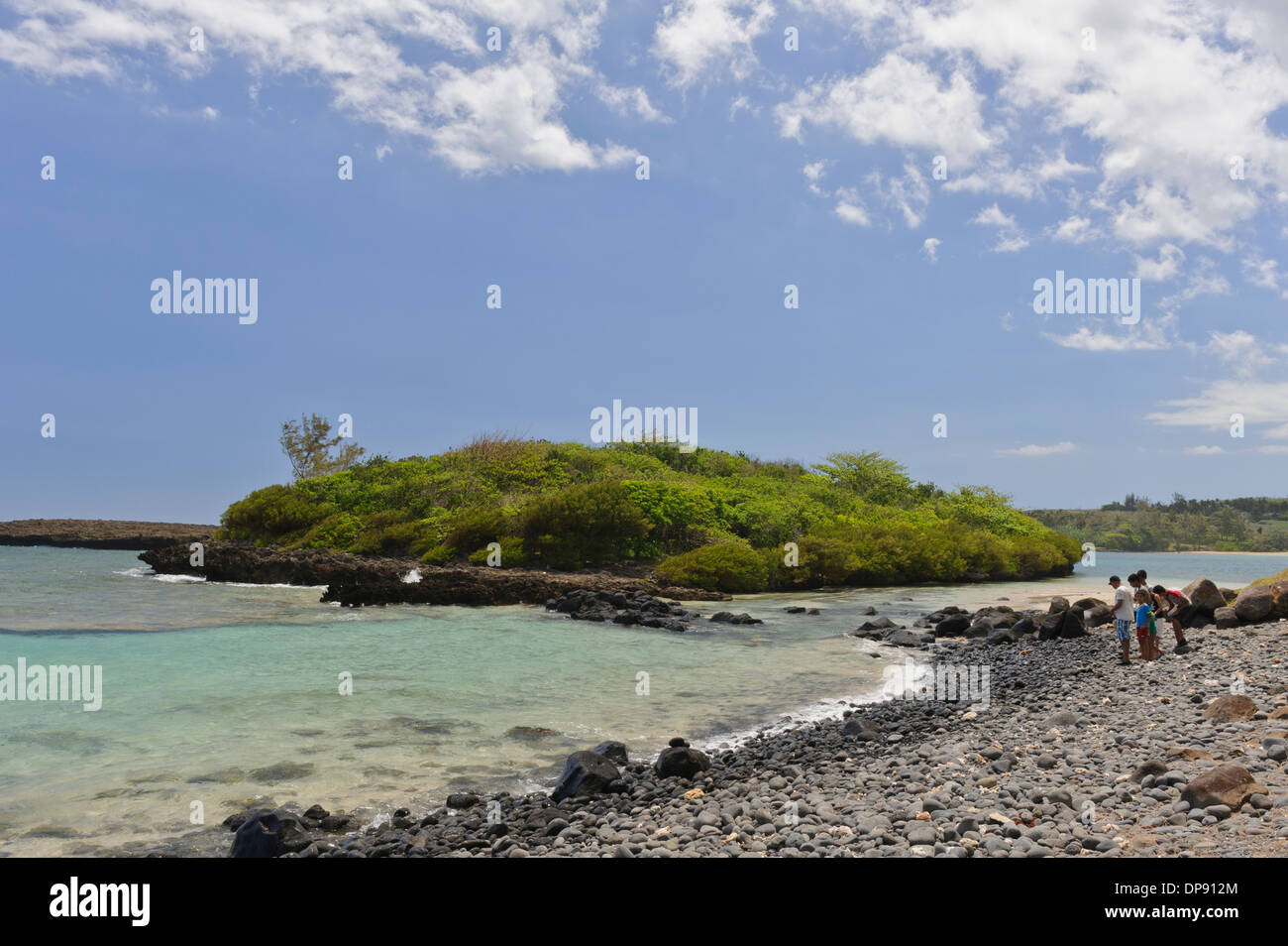 Pebbles of all sizes cover the beach by Iles ilot Sancho, a small deserted island in  the savannah district, Mauritius. Stock Photo