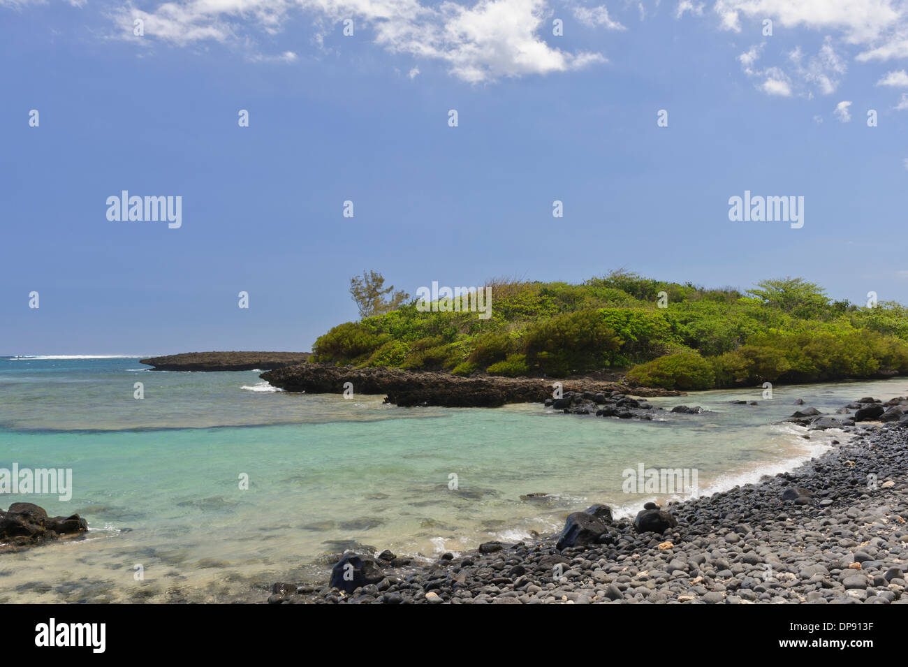 Pebbles of all sizes cover the beach by Iles ilot Sancho, a small deserted island in  the savannah district, Mauritius. Stock Photo