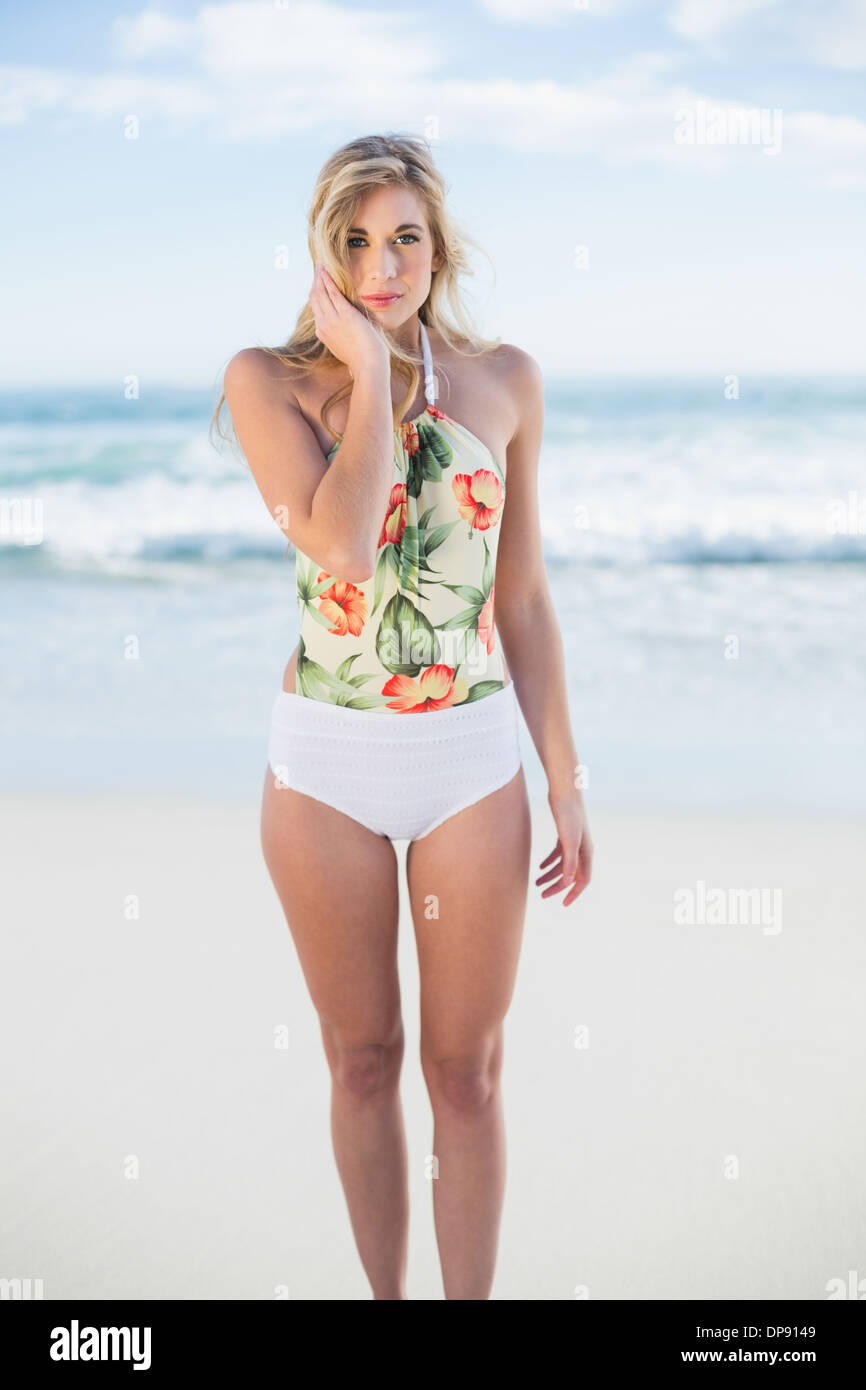 Stern blonde model in swimsuit posing looking at camera Stock Photo