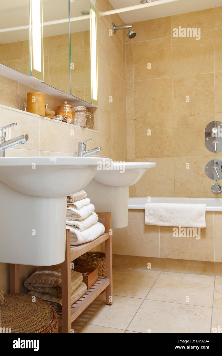 Twin basins in a bathroom clad with stone tiles Bowling Hall home