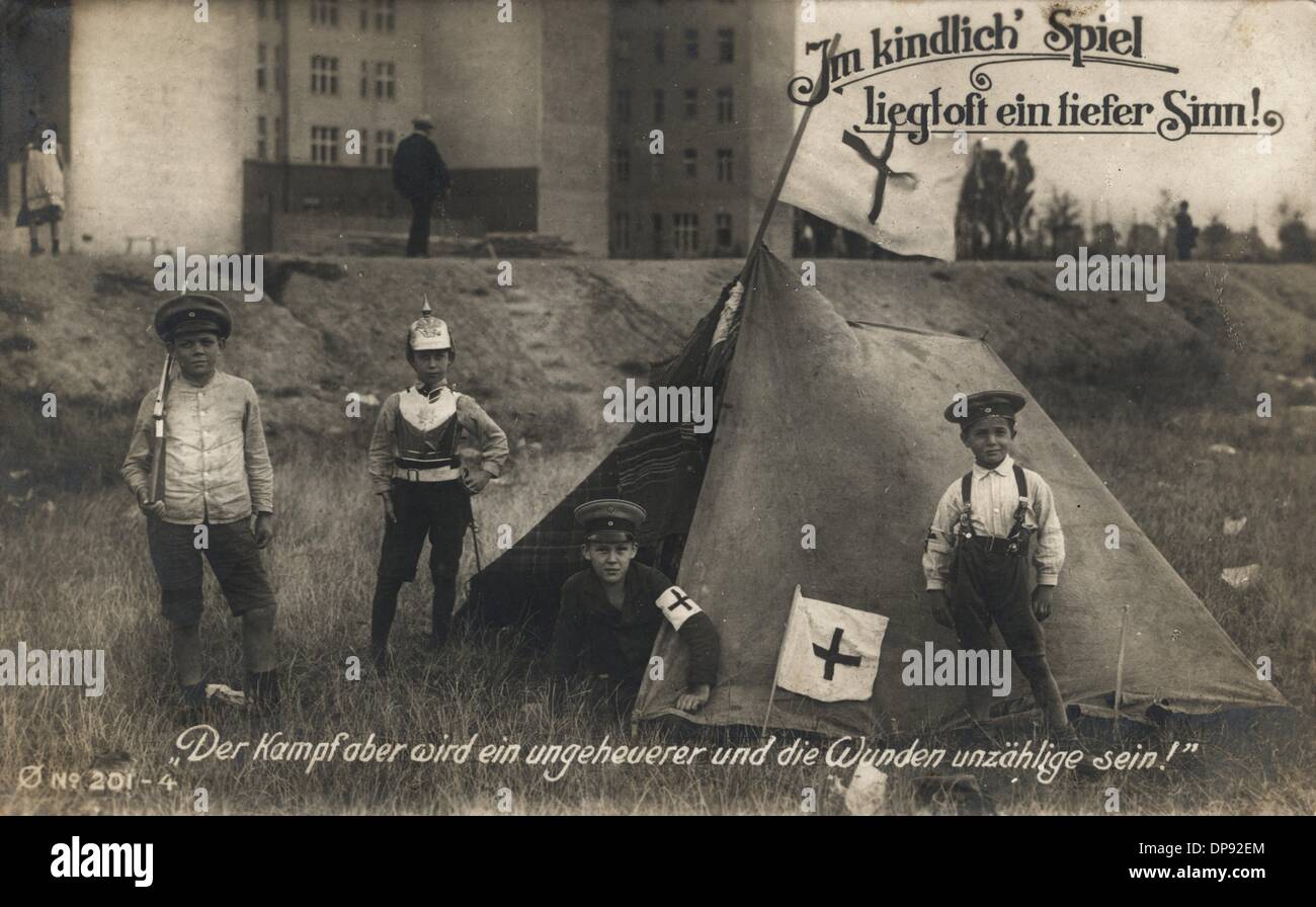 The field postcard from 1915 depicts children in uniform playing war with a medical tent of the German Red Cross. The postcard reads 'The game of children often bears a deeper sensen!' and 'But the battle will be tremendous one and the wounds will be innumerable!'. Photo: Sammlung Sauer Stock Photo
