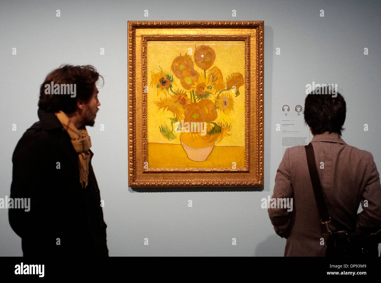 visitors to the van gogh museum gallery in amsterdam with sunflowers by