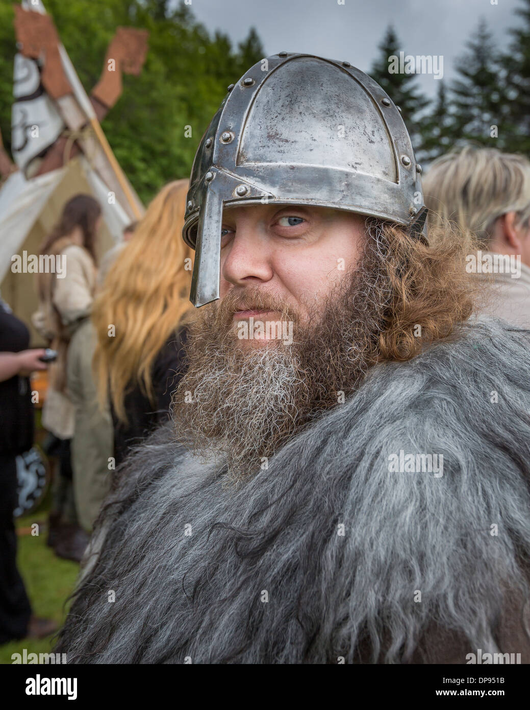 Portrait of male with beard and helmet dressed for a Viking festival ...