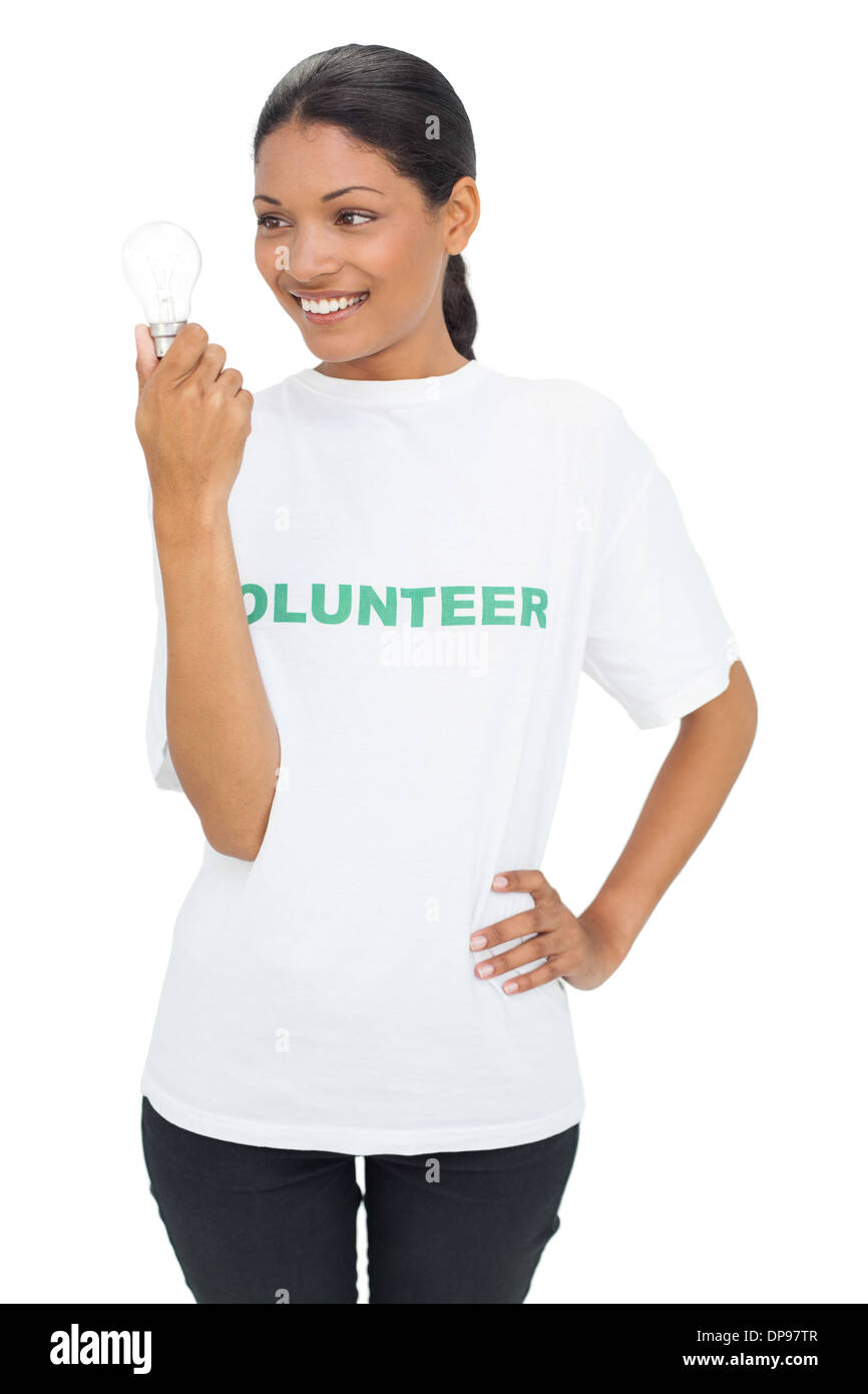Smiling model wearing volunteer tshirt holding light bulb Stock Photo