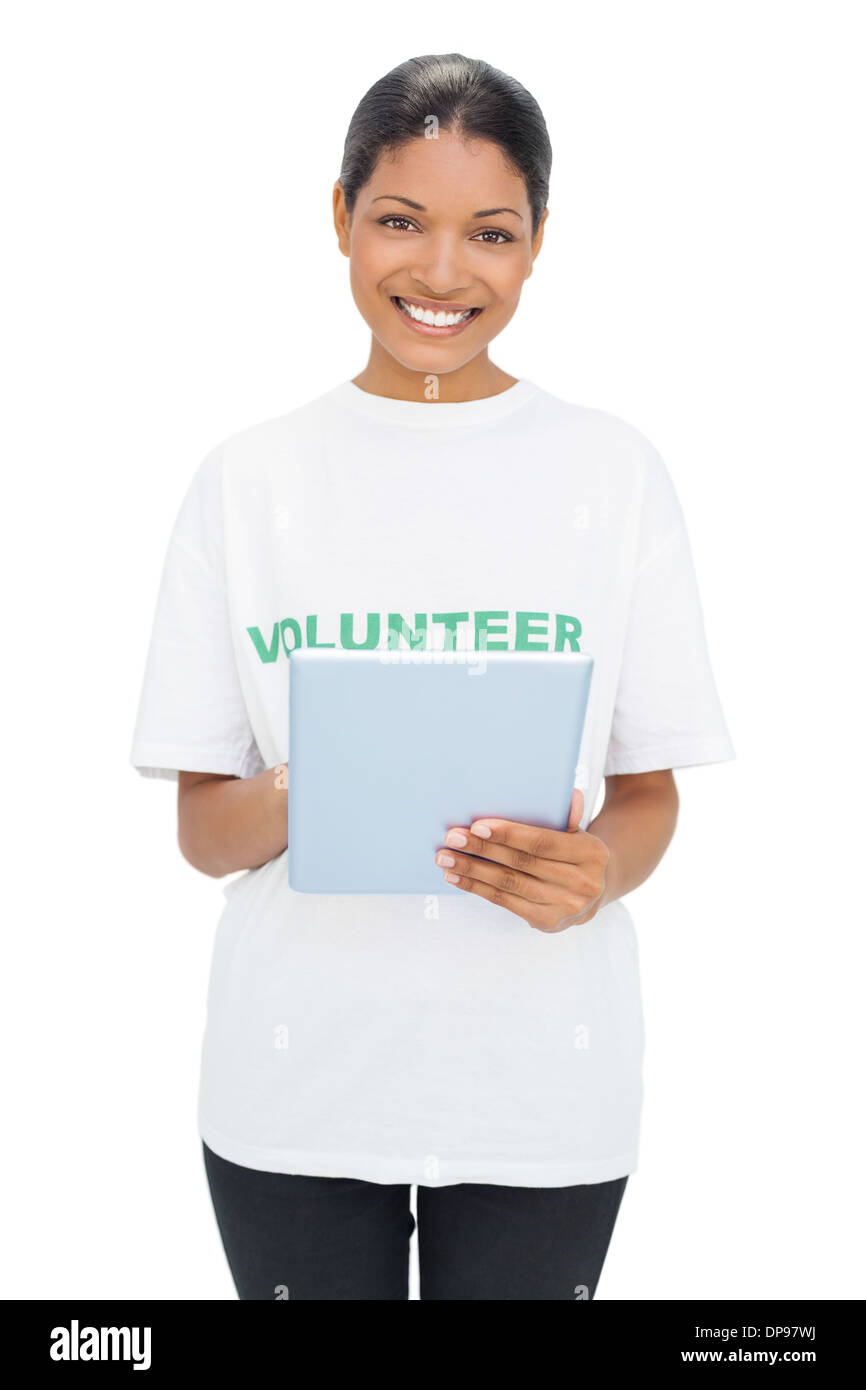 Happy model wearing volunteer tshirt holding tablet Stock Photo