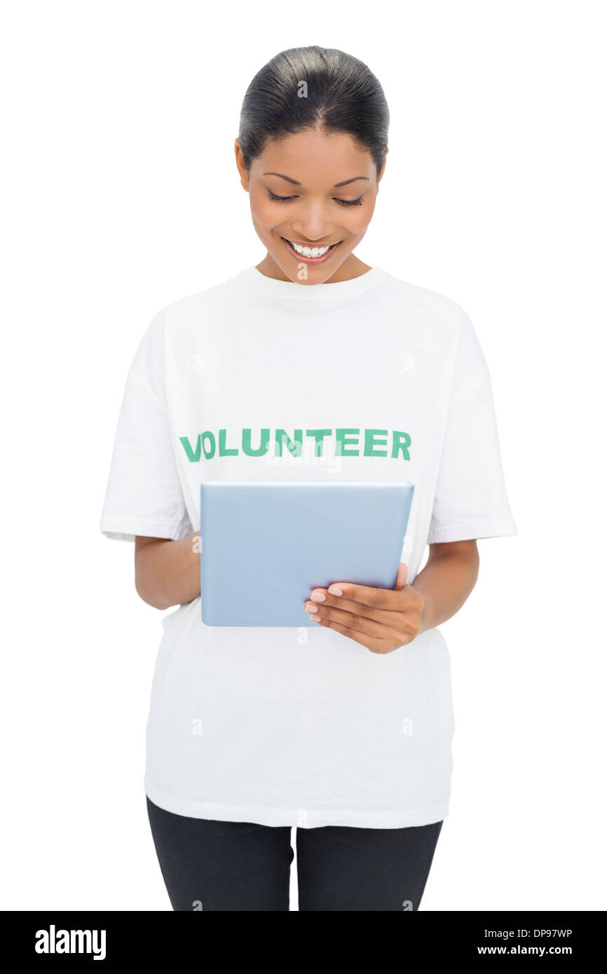 Smiling model wearing volunteer tshirt holding tablet Stock Photo