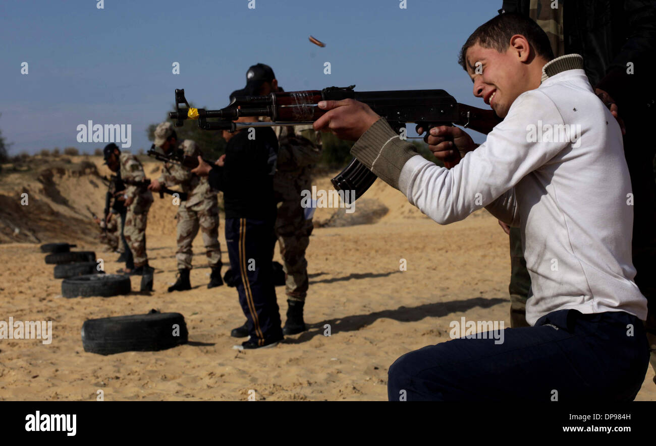 Rafah, Gaza Strip, . 9th Jan, 2014. Palestinian high school students take part in a military-styled exercise routine at a course held by the Hamas-run ministry of education. Students learn how to abseil from buildings, run through obstacle courses and crawl under barbed wire in a one-hour mandatory session each week. Older also learn how to use light weapons, while younger ones practice with mock wooden rifles. Credit:  Ashraf Amra/APA Images/ZUMAPRESS.com/Alamy Live News Stock Photo