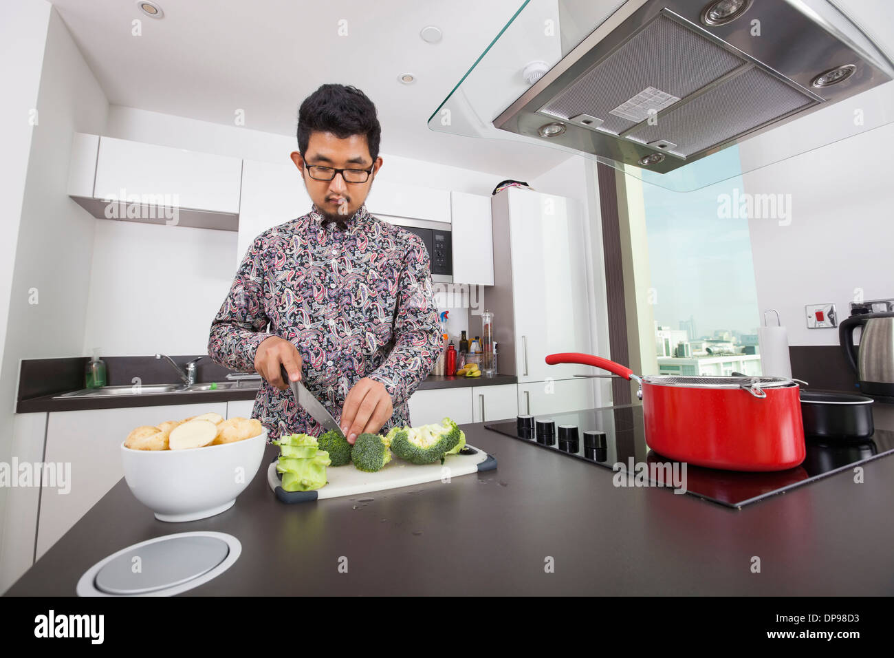 Man Cutting Broccoli At Kitchen Counter Stock Photo 65357743 Alamy