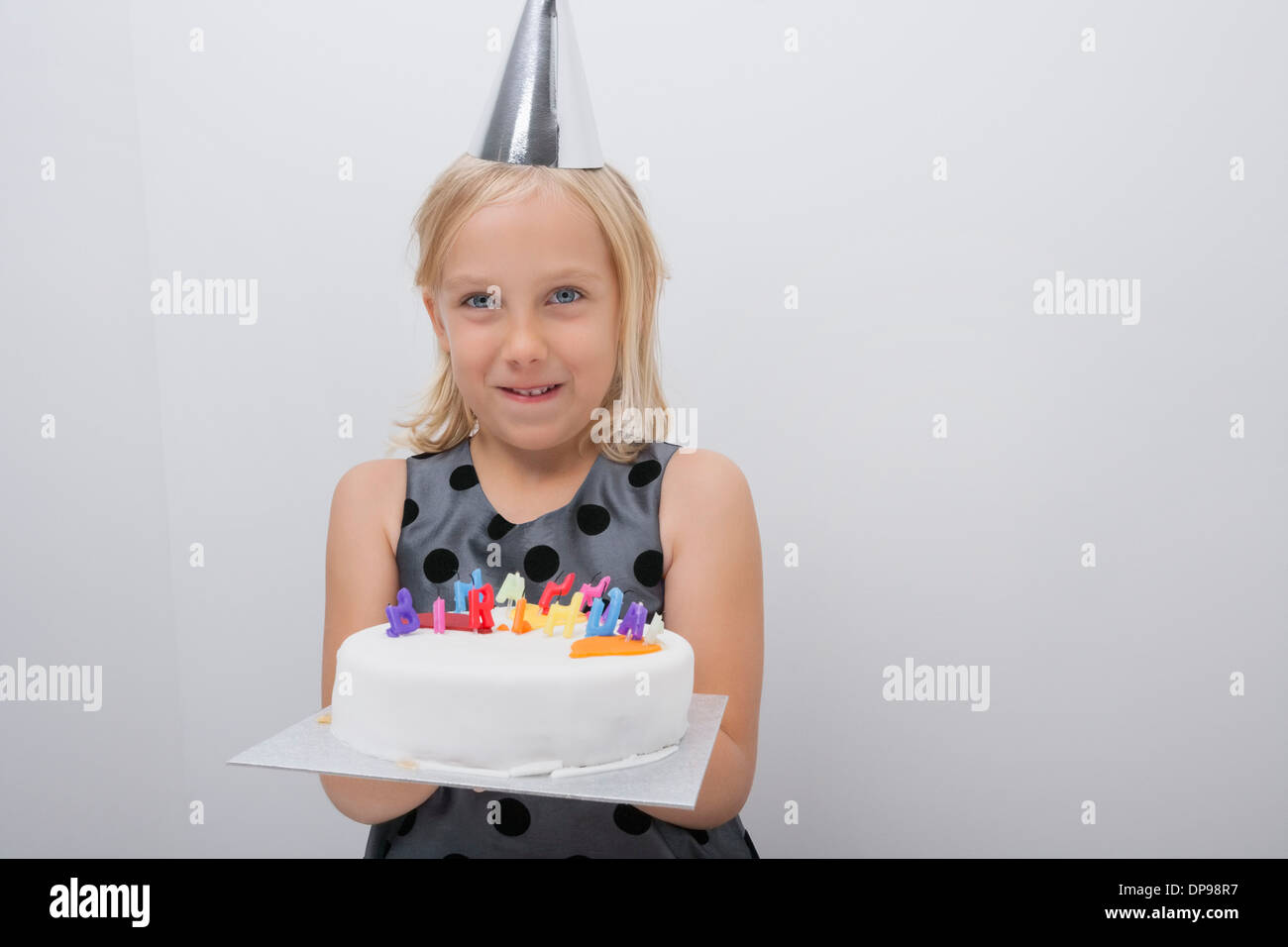Portrait of happy girl holding birthday cake at home Stock Photo - Alamy