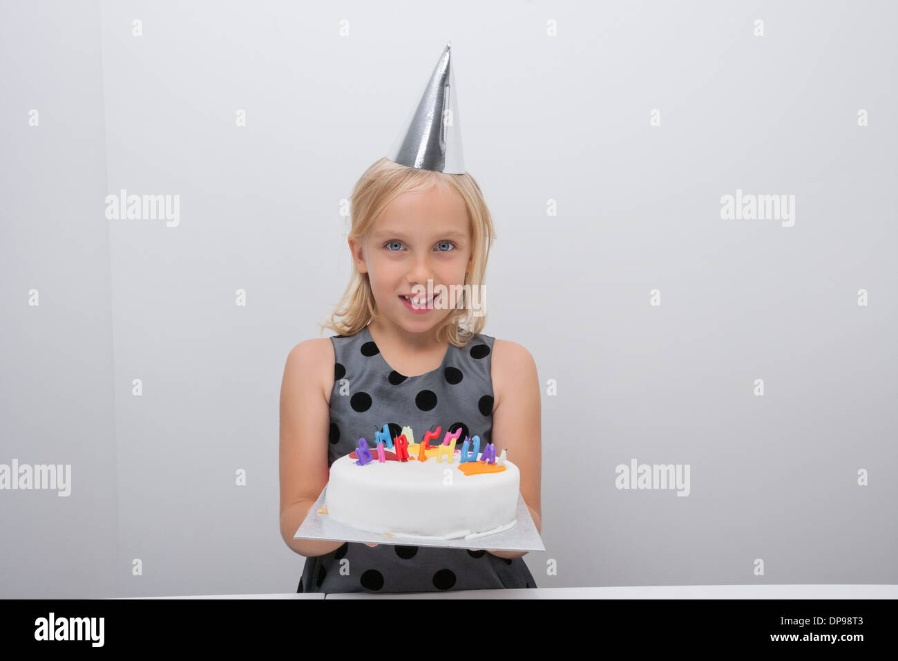 Portrait of cute girl holding birthday cake at home Stock Photo - Alamy