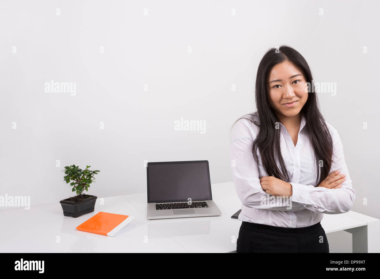 Smiling asian businesswoman arms hi-res stock photography and images ...