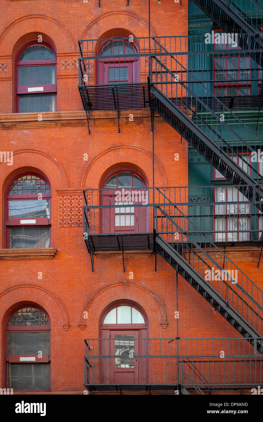 Red brick apartment building with fire escapes, SOHO, Manhattan, New York City, USA Stock Photo
