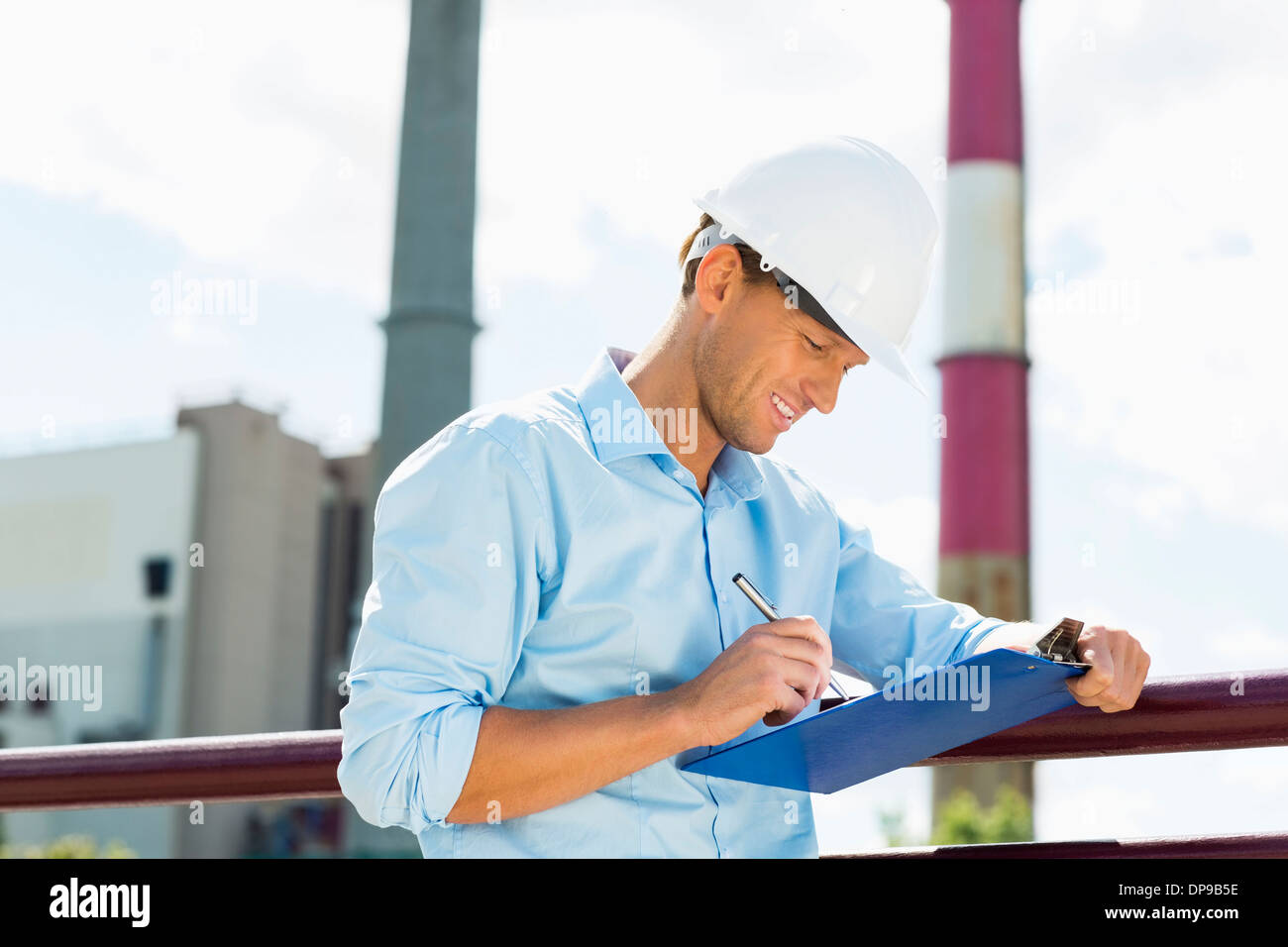 Male architect writing on clipboard at site Stock Photo Alamy