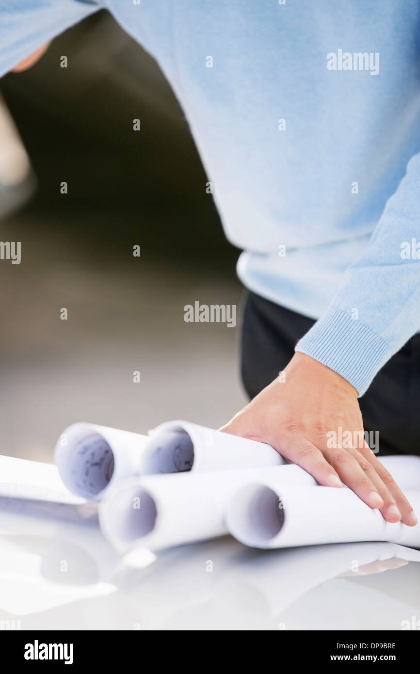 Midsection of architect with blueprints Stock Photo