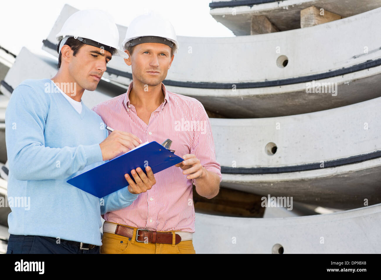 Architects with clipboard working at construction site Stock Photo Alamy