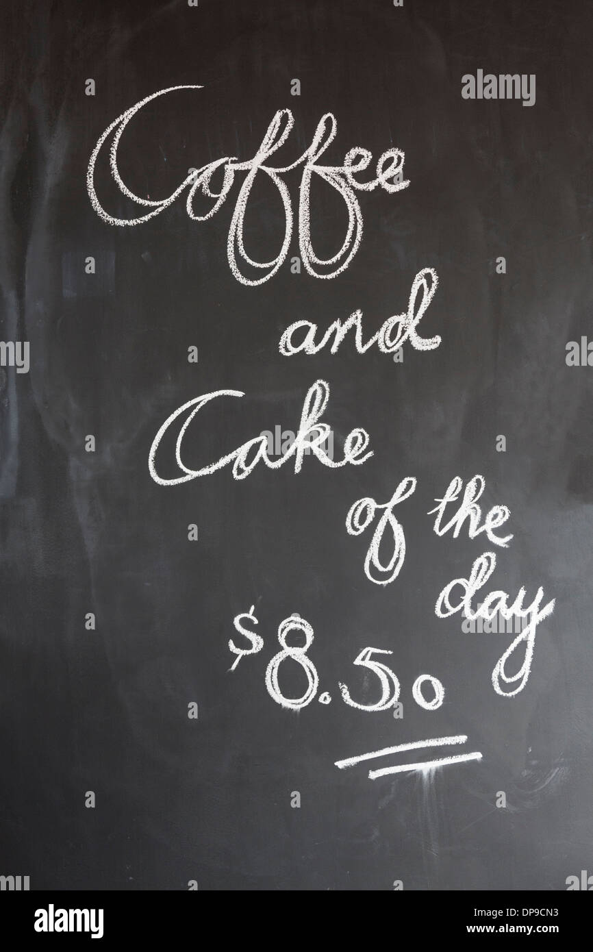 Coffee and cake of the day sign on a blackboard in cafe Stock Photo