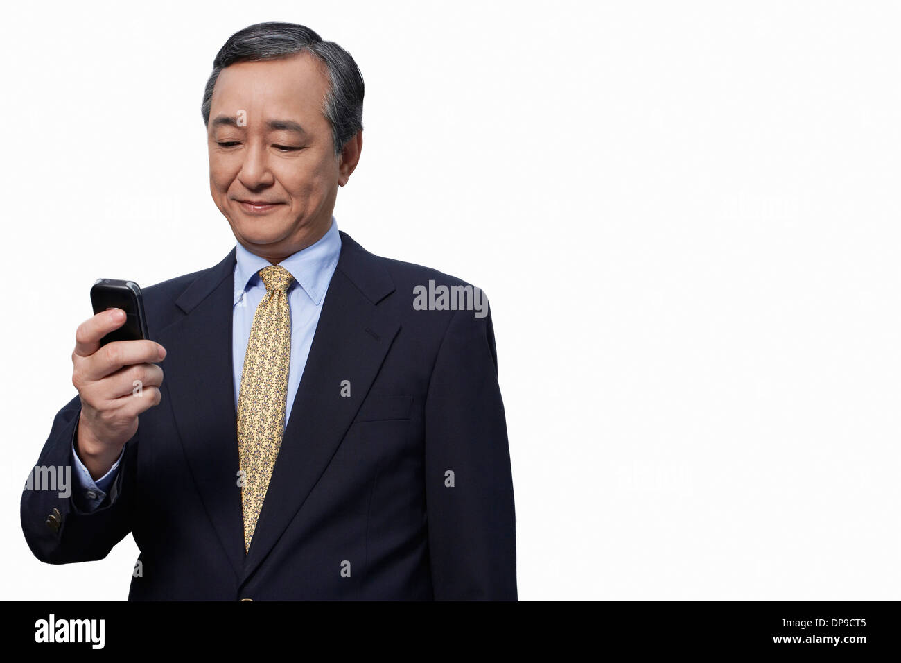 Businessman text messaging on cell phone over white background Stock Photo