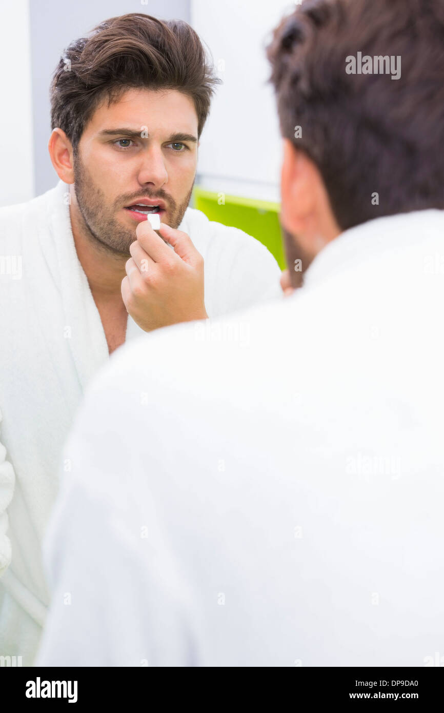 Reflection of man taking medicine at home Stock Photo
