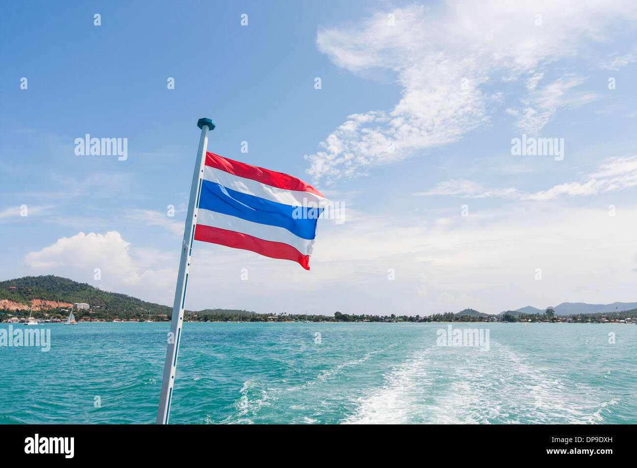 Thailand flag with boat wake at Koh Pha Ngan island Stock Photo