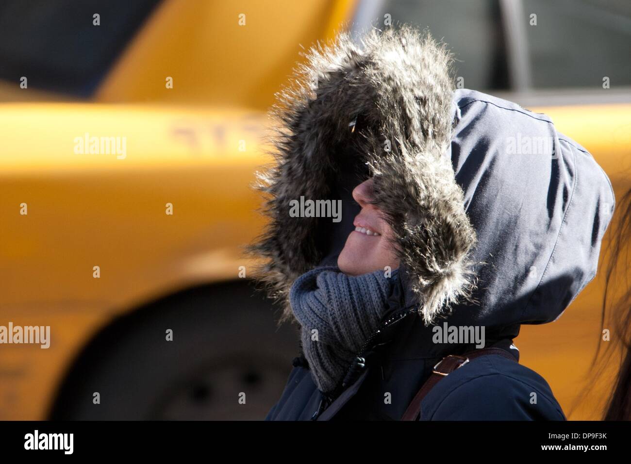 New York, YSA, USA. 7th Jan, 2014. A blast of record-breaking arctic air hit the United States on Tuesday, 7 January, 2014, causing at least 17 deaths and widespread transportation delays. All 50 U.S. states recorded temperatures below freezing. New York City's Central Park recorded its lowest temperature for 7 January, -15.5 degrees Celsius (4 degrees Fahrenheit) in 118 years. In photo, a woman in a parka looks up at buildings near Madison Square Garden in New York City. Photo: Mati Milstein/NurPhoto Credit:  Mati Milstein/NurPhoto/ZUMAPRESS.com/Alamy Live News Stock Photo