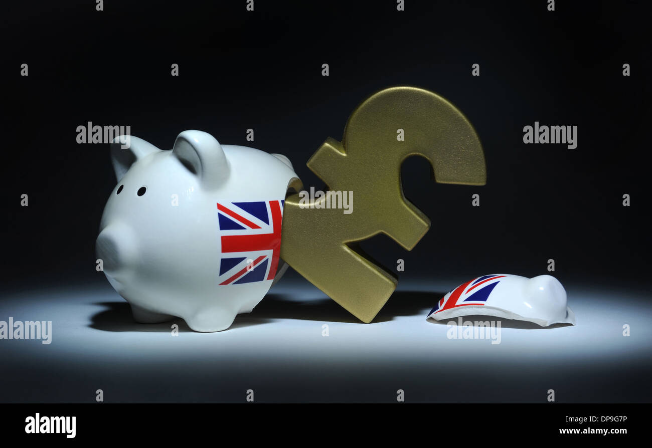BROKEN PIGGY BANK WITH EMERGING BRITISH POUND SIGN RE INCOMES RETIREMENT THE ECONOMY PRICES WAGES ECONOMIC RECOVERY JACK CASH Stock Photo
