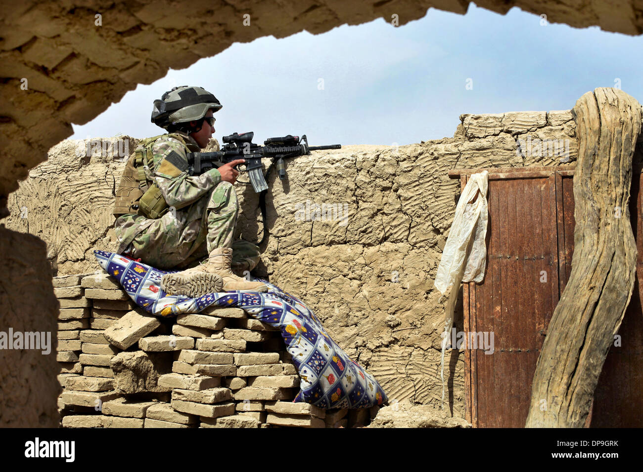 Member of an Afghan-international security force secures the area while in pursuit of militants, Kandahar District, Afghanistan Stock Photo