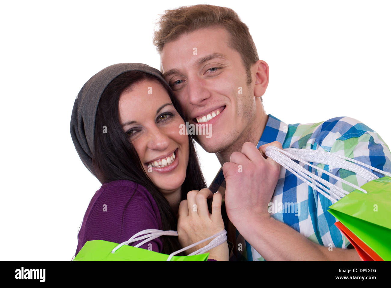 A smiling young couple with shopping bags, isolated on a white background Stock Photo