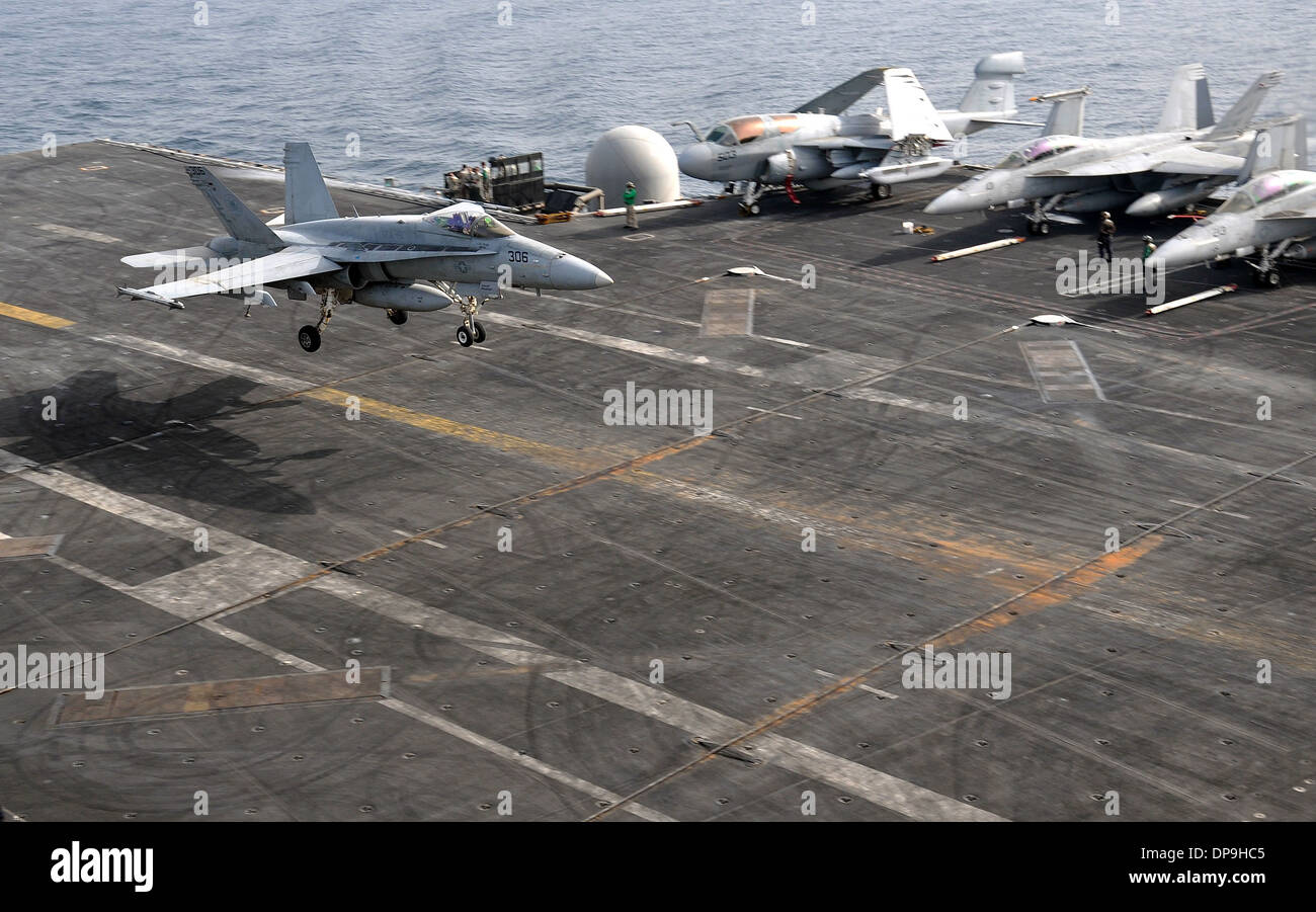 U.S. Navy F/A-18C Hornet aircraft lands aboard the aircraft carrier USS Abraham Lincoln Stock Photo