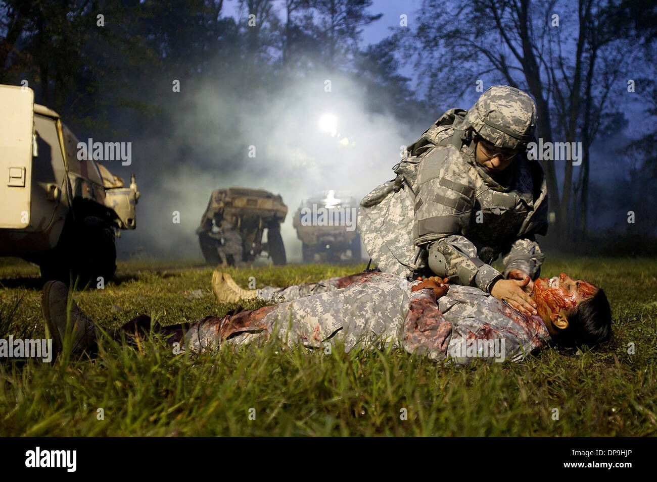 Sgt. Sherri Gallagher assesses a mock casualty during the warrior skills lane at the U.S. Army Best Warrior Competition Stock Photo