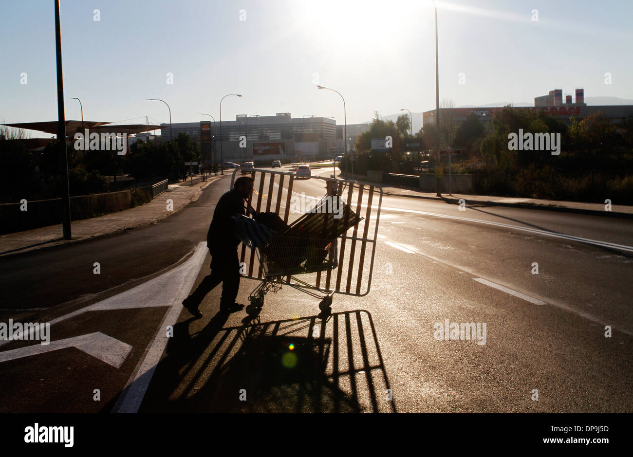 A junkman pushes his trolley where he picks between the junk copper, iron and steel to seel on local junkyards, Mallorca, Spain Stock Photo