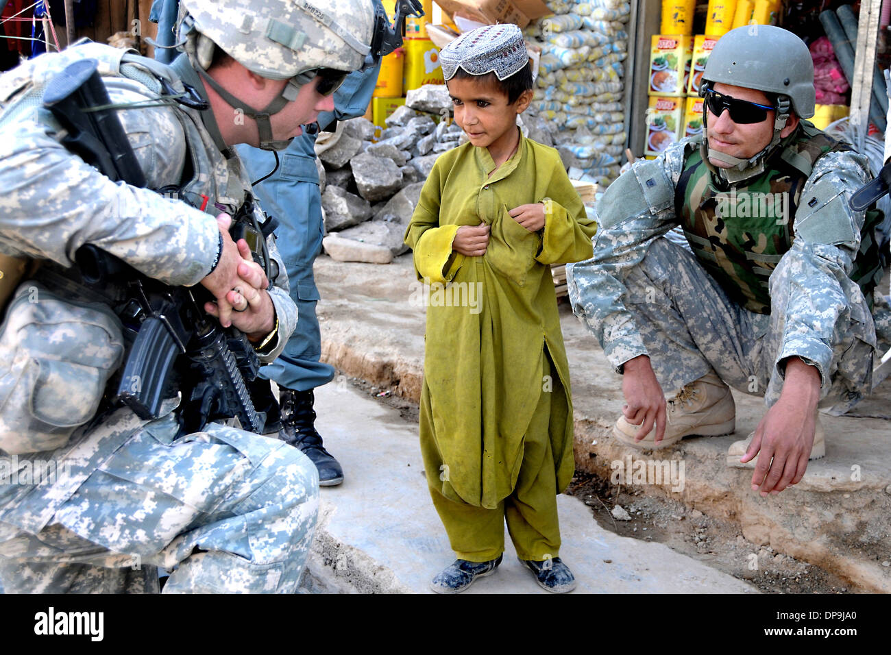 U.S. soldiers talk to a boy in Zabul Province, Afghanistan Stock Photo
