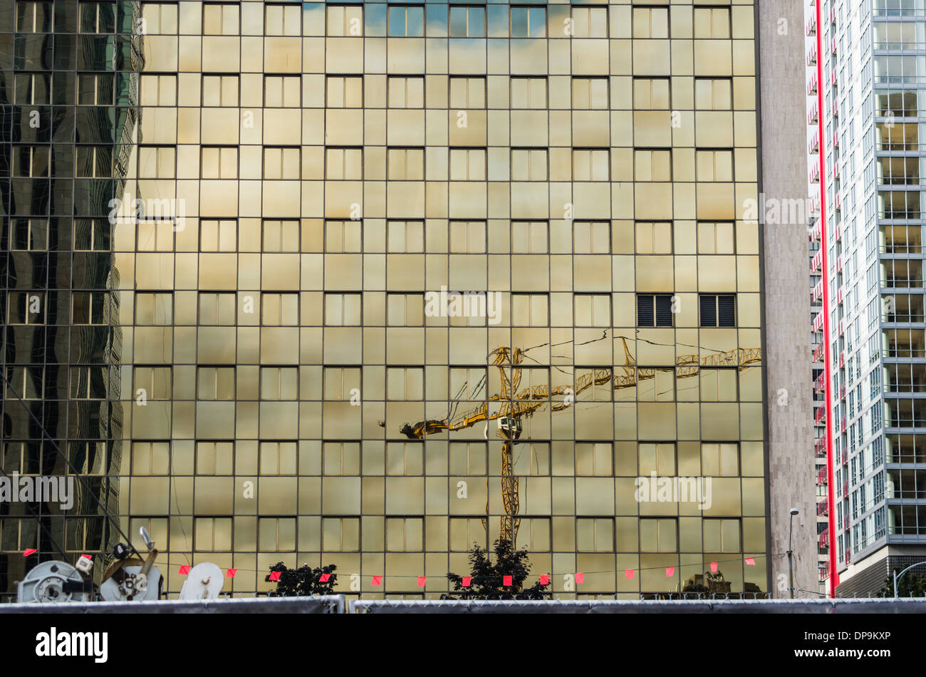 Construction crane reflected in the windows of an office building downtown Seattle. Seattle, Washington Stock Photo