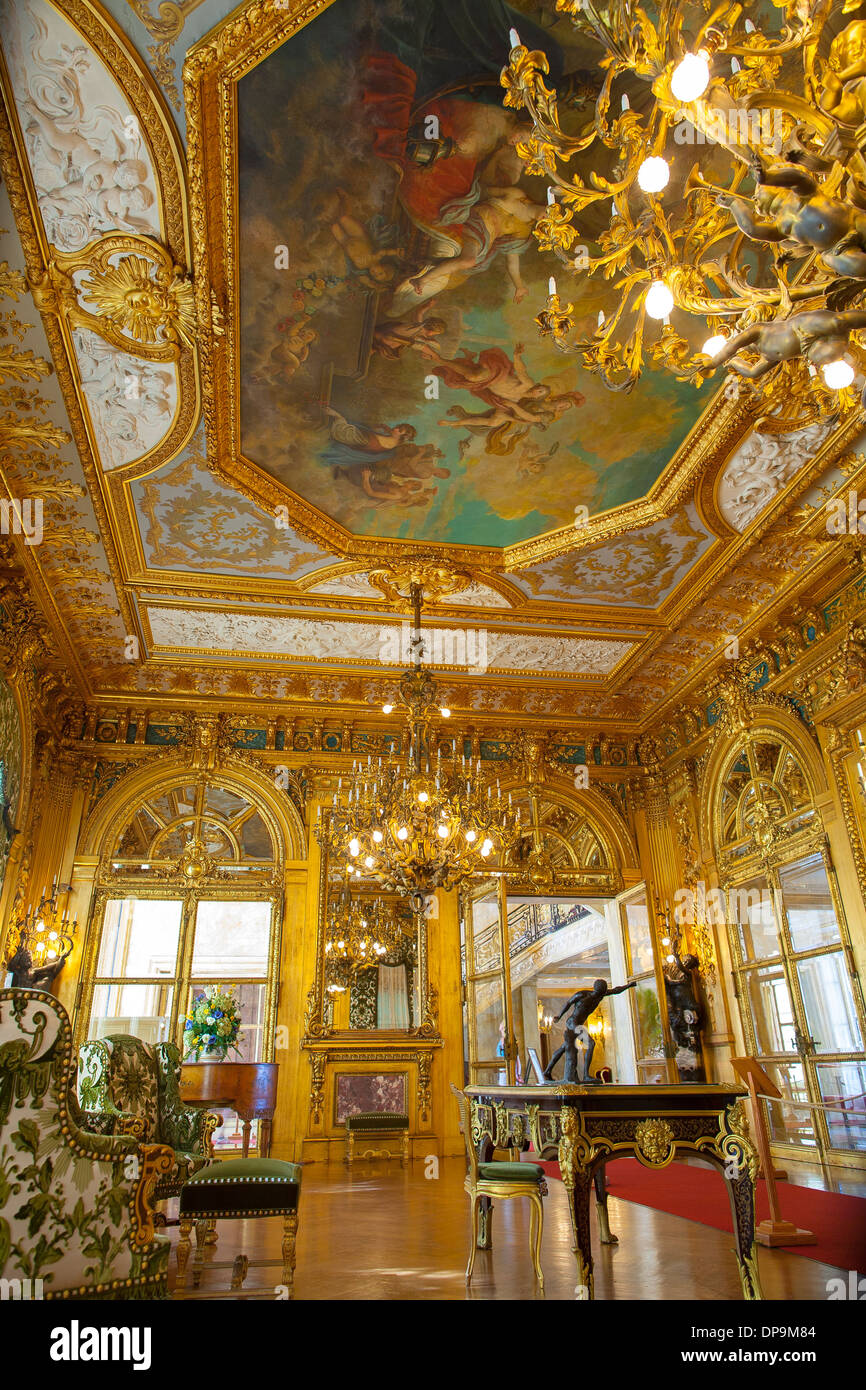 Elaborate decoration and chandelier of the gold room in Marble House, one of Newports most famous summer cottages or mansions Stock Photo