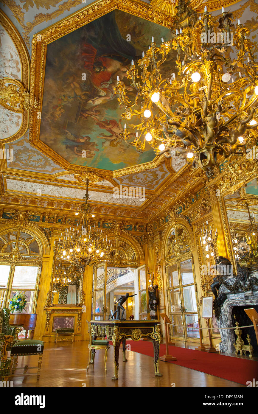 Elaborate decoration and chandelier of the gold room in Marble House, one of Newports most famous summer cottages or mansions Stock Photo