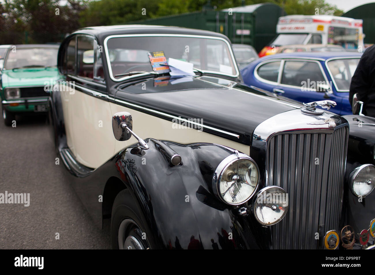 A classic Jaguar motor car on display at a rural community farm