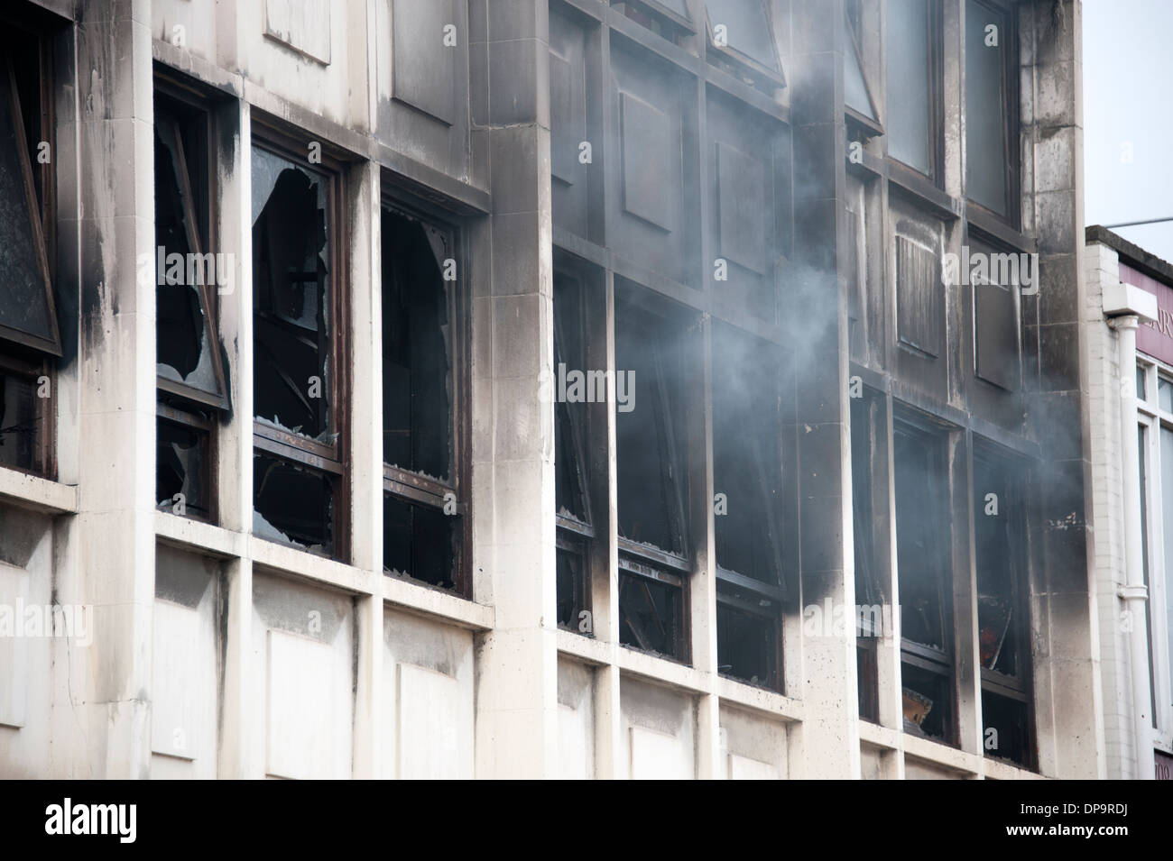 Smoke pouring from windows of commercial building Fire Stock Photo
