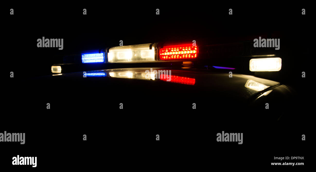 A police car at night with its lights on. Stock Photo