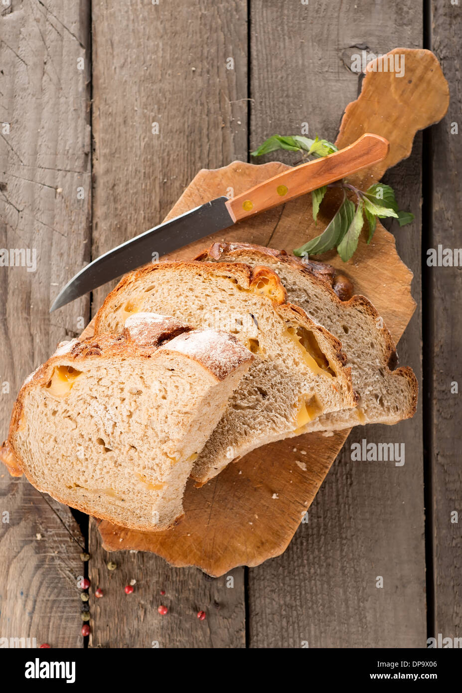 Bread and knife on a cutting board Stock Photo