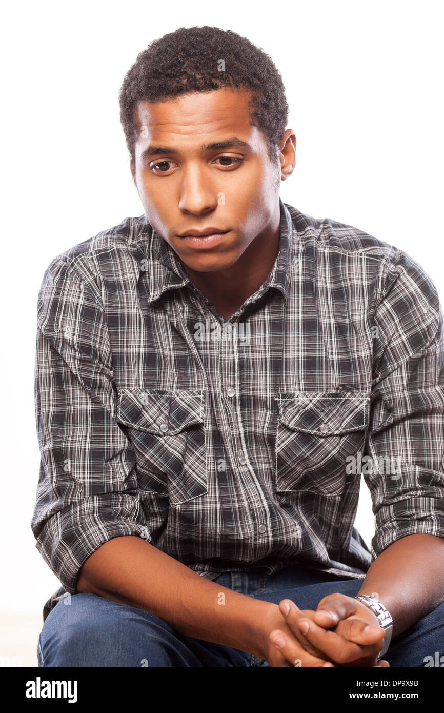 Dark Skinned Young Man Posing With A Sad Expression On White Stock