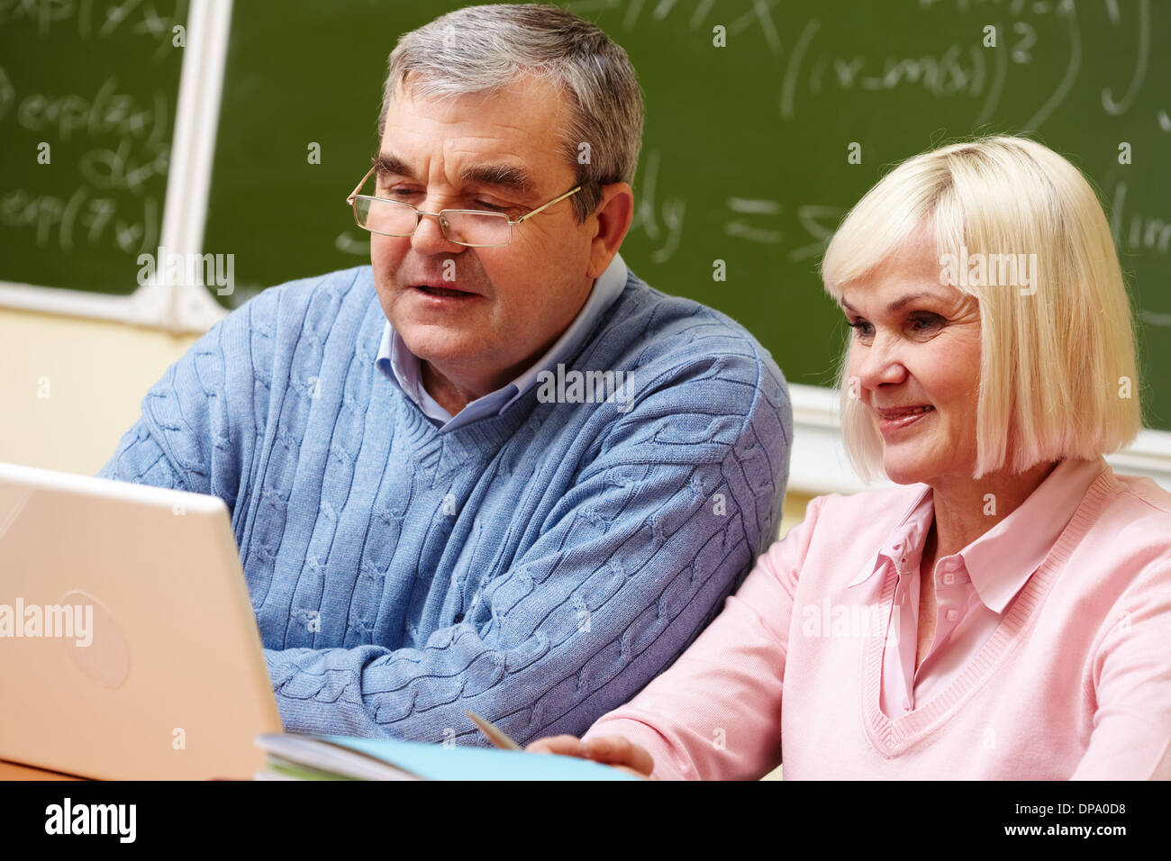 Elderly people using modern technologies for studying Stock Photo