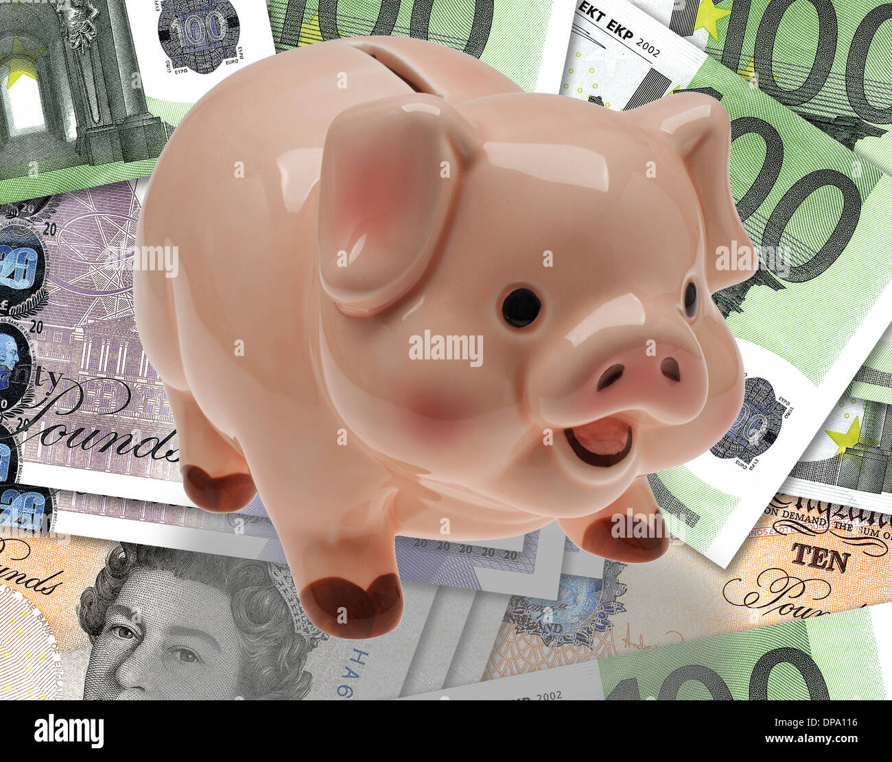 China/ceramic child’s savings or piggy bank on background of pound and euro currency. Stock Photo