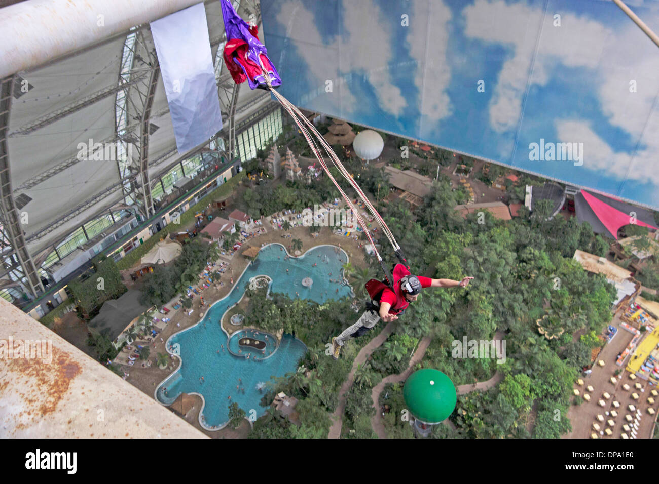 A base jumper exited from a indoor platform and his parachute is