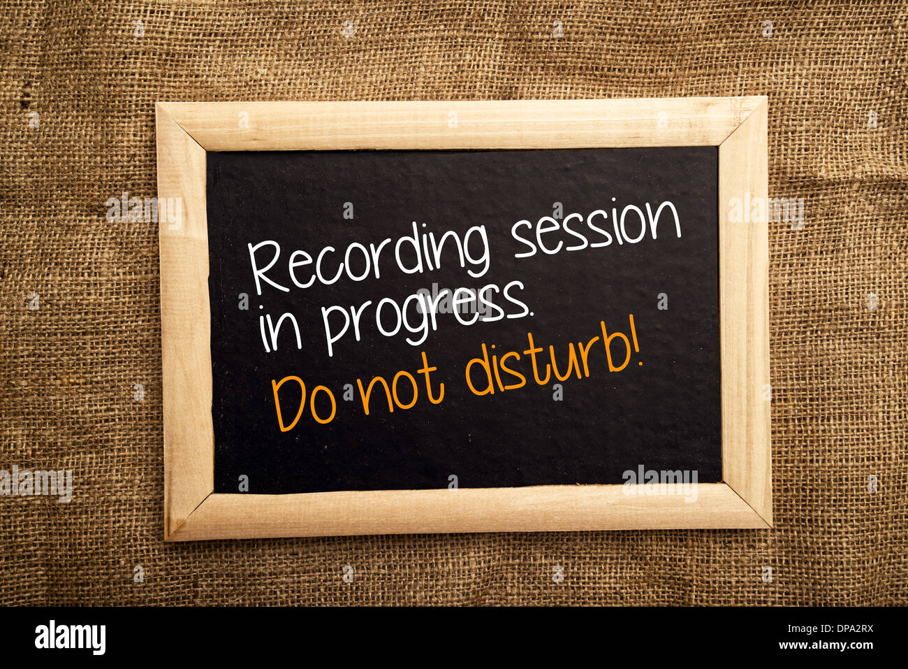 Recording session in progress. Do not disturb note on black message board Stock Photo