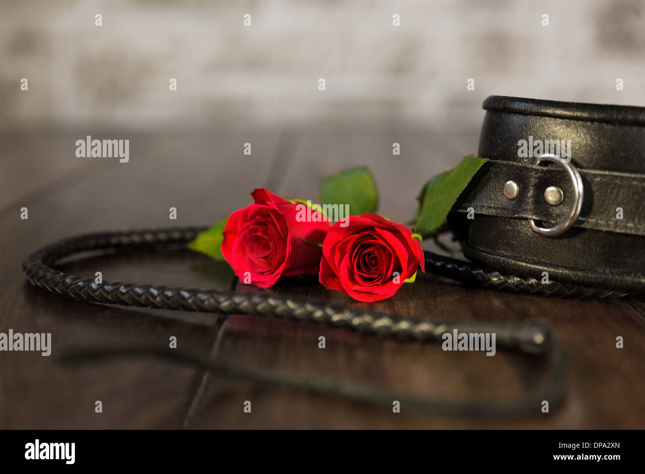closeup from bdsm toys and a red rose Stock Photo - Alamy