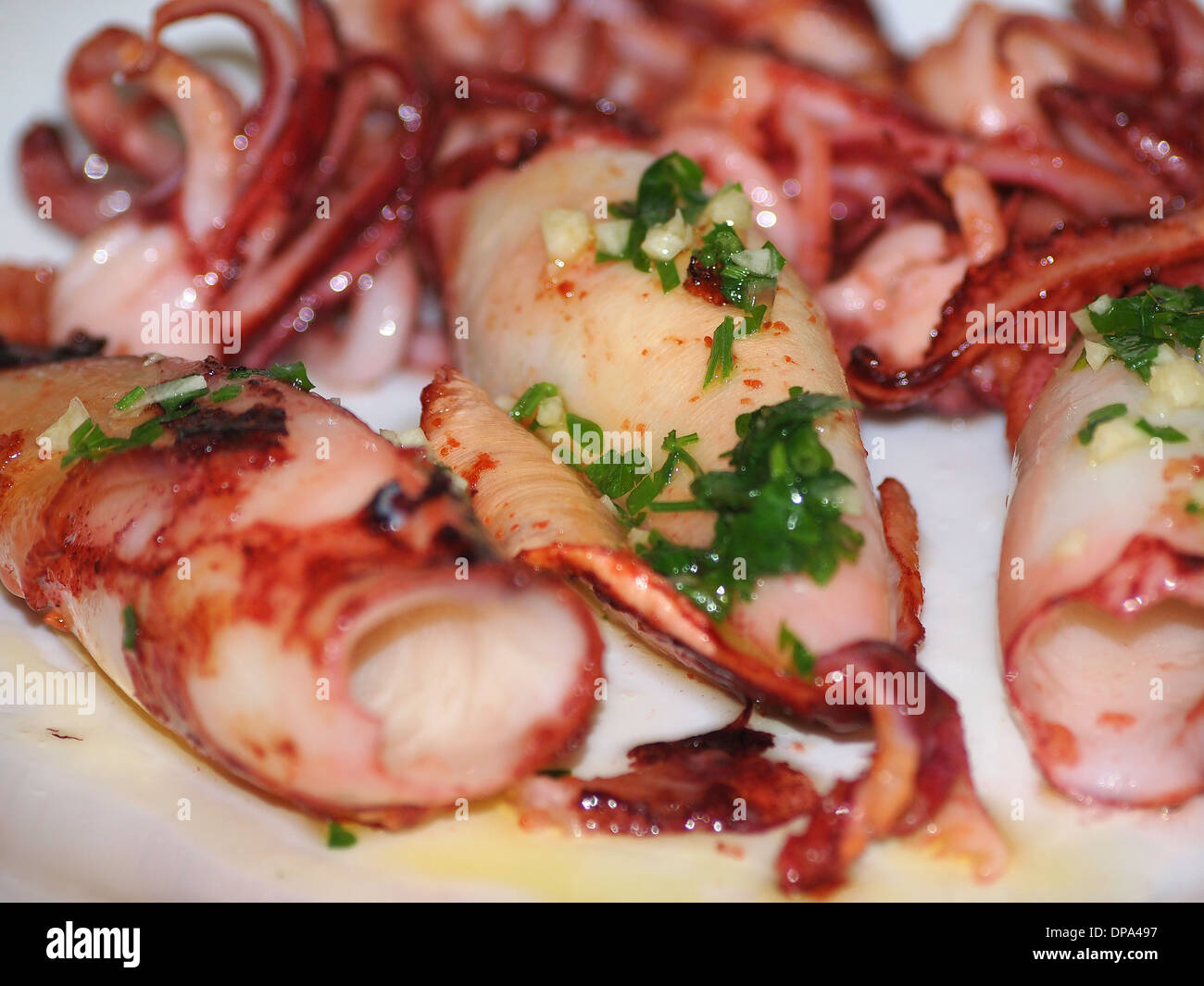 Delicious grilled squids with garlic and parsley, Greece Stock Photo