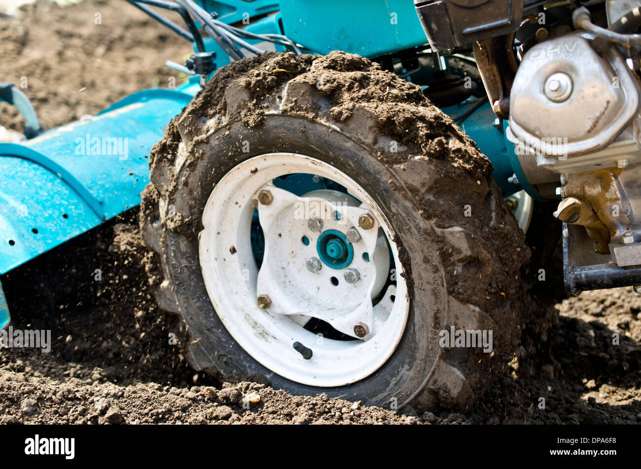 Powerfull tiller ploughing the soil Stock Photo Alamy