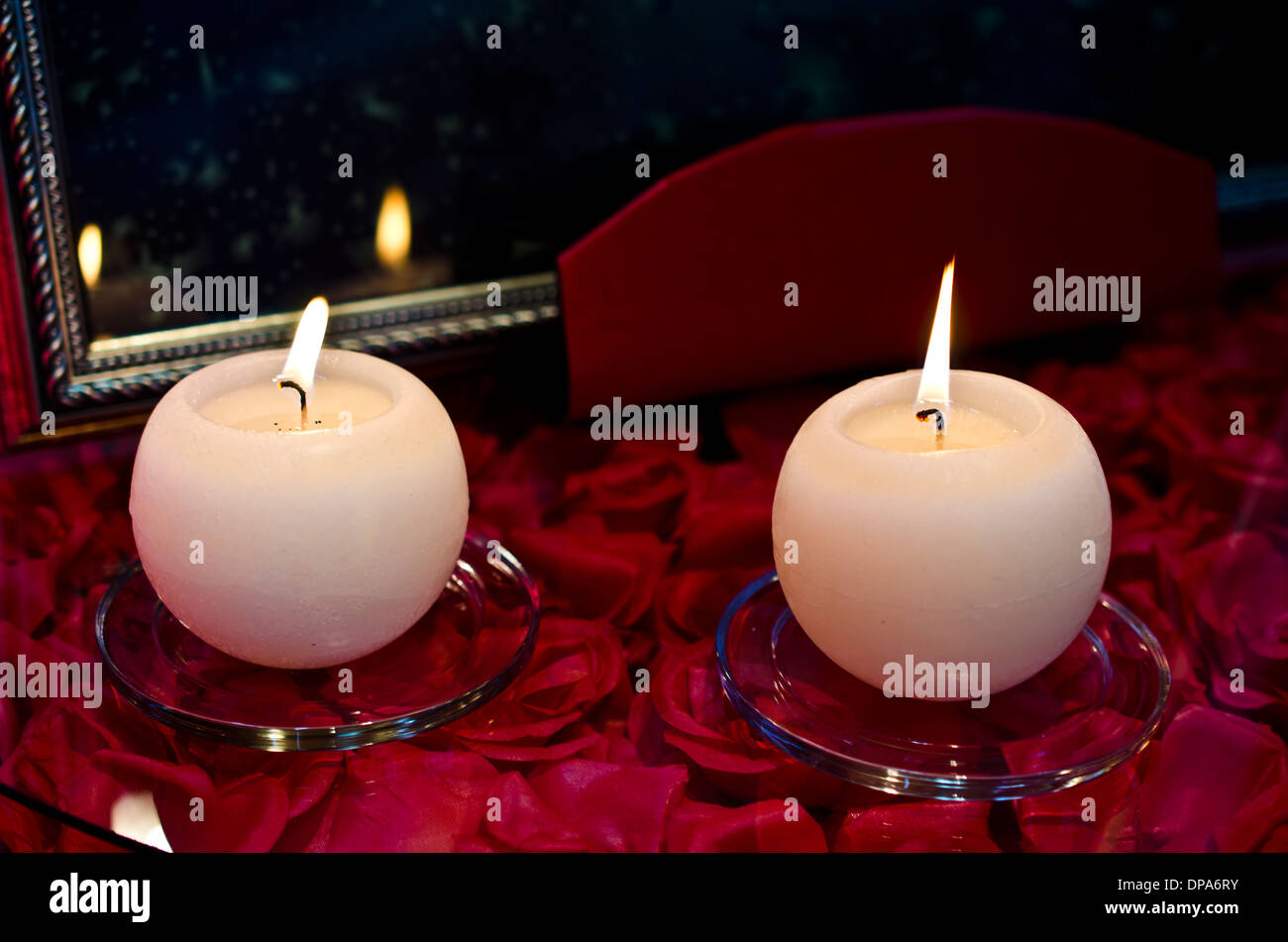 Burning candles on red roses Stock Photo Alamy